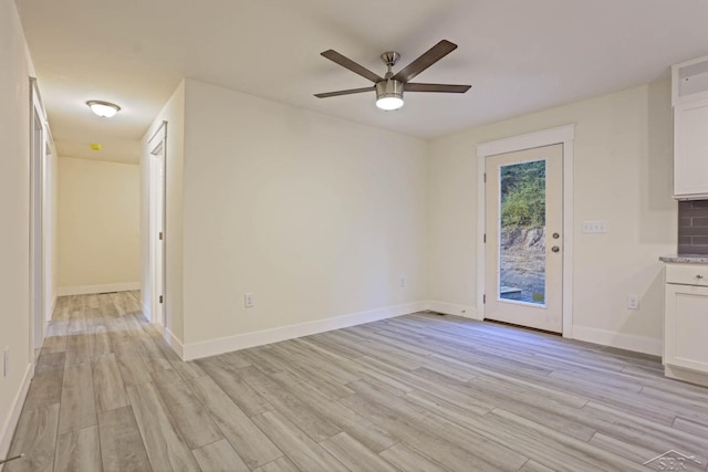 unfurnished living room with ceiling fan and light hardwood / wood-style floors