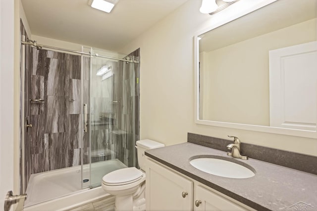 bathroom featuring vanity, toilet, and an enclosed shower