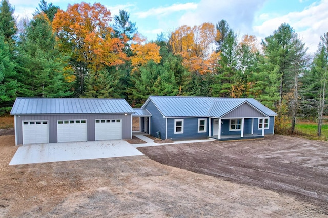 single story home featuring an outdoor structure, a porch, and a garage