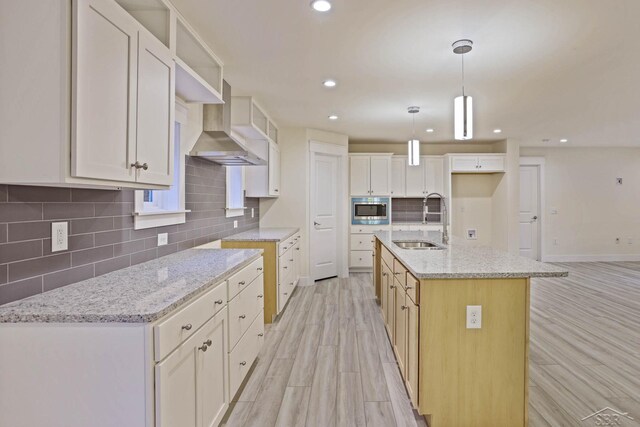 2210 Fox Run Rd, West Branch, MI 48661 - kitchen featuring a sink, tasteful backsplash, wall chimney range hood, light wood-style floors, and recessed lighting
