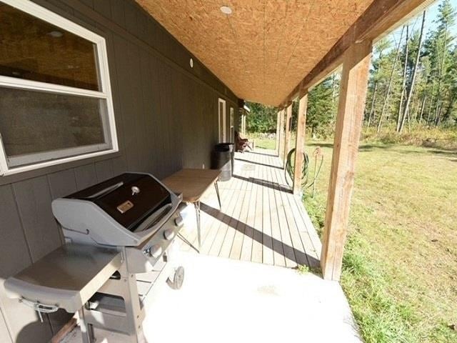 wooden deck featuring a yard