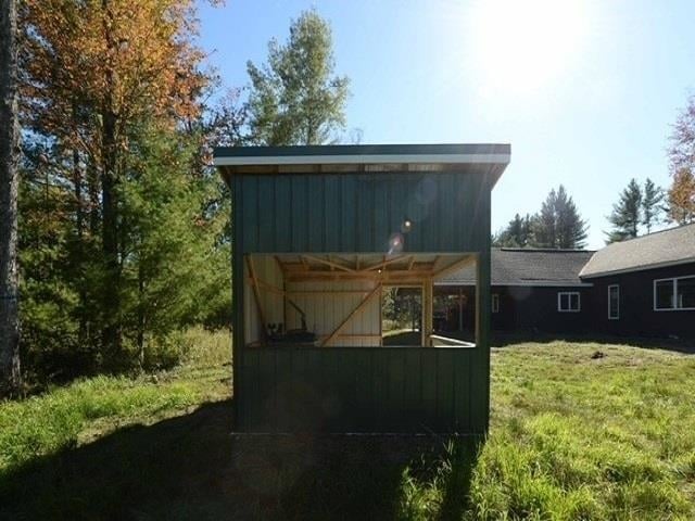 view of outdoor structure featuring a yard