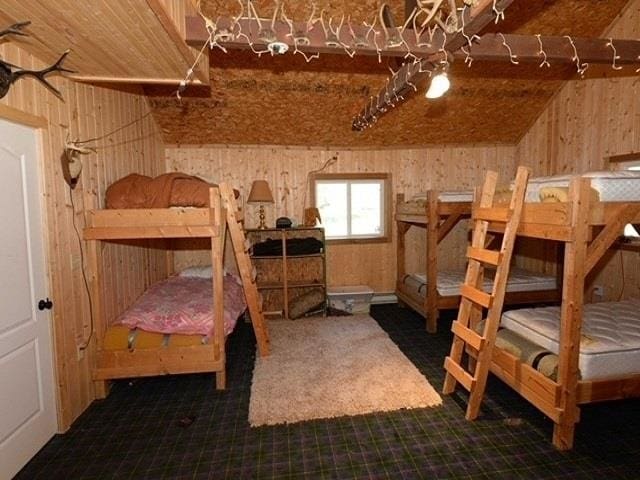 unfurnished bedroom featuring wood walls