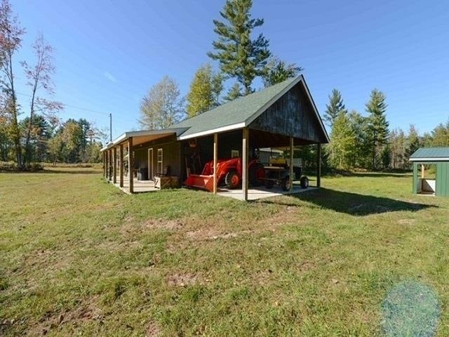 exterior space with a lawn and an outdoor structure