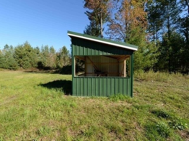 view of outbuilding featuring a lawn