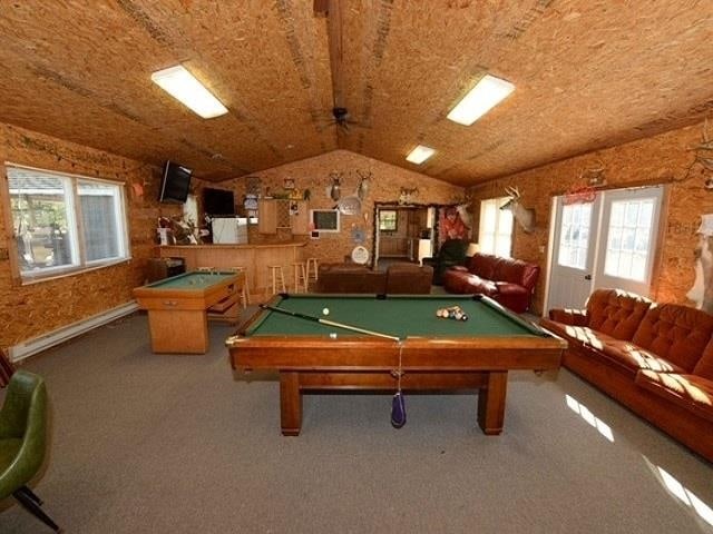 recreation room featuring lofted ceiling, carpet floors, and billiards