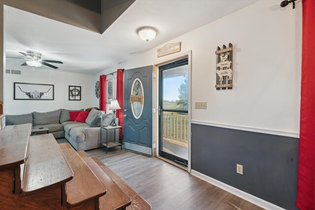 living room featuring hardwood / wood-style flooring and ceiling fan