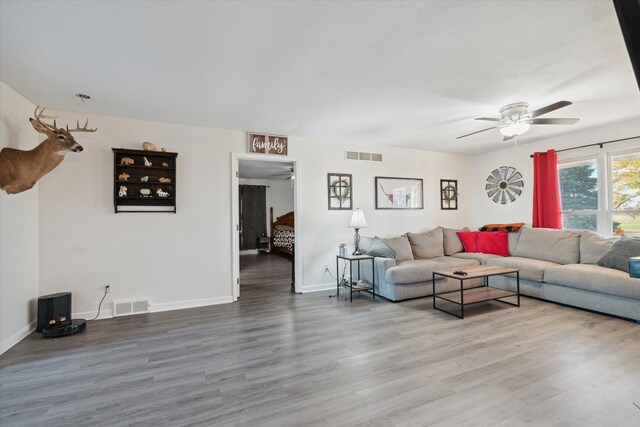 living room with hardwood / wood-style floors and ceiling fan