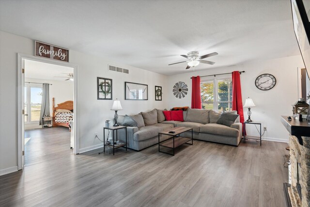 living room with hardwood / wood-style floors and ceiling fan