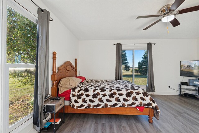 bedroom with dark hardwood / wood-style floors and ceiling fan