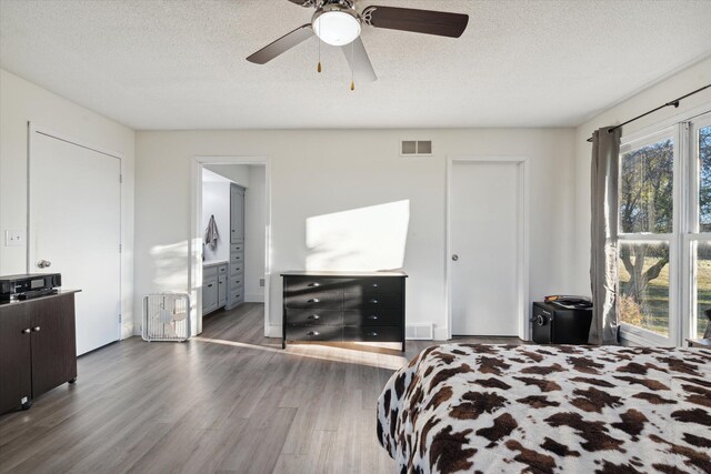 16248 Wabash Rd, Waldron, MI 49288 - bedroom with wood finished floors, a textured ceiling, ensuite bath, and a ceiling fan