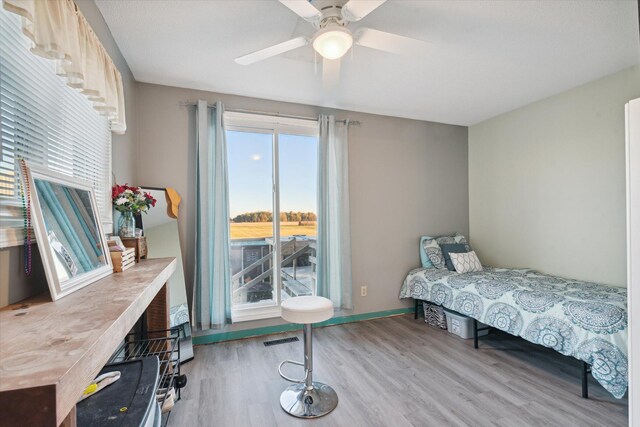 bedroom with ceiling fan and light hardwood / wood-style floors