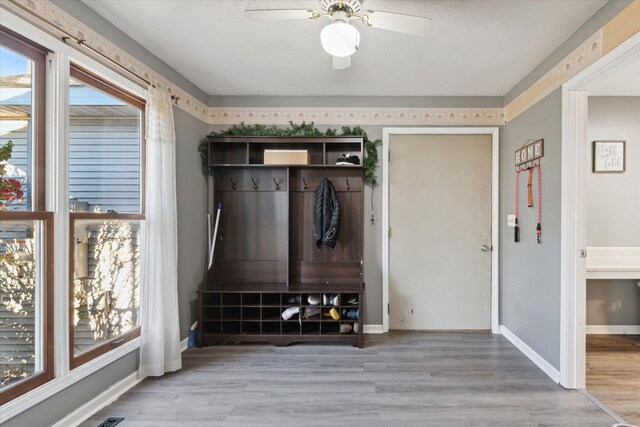 mudroom featuring ceiling fan, a textured ceiling, and light wood-type flooring