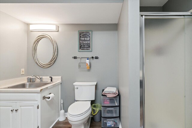 16248 Wabash Rd, Waldron, MI 49288 - full bath featuring vanity, a stall shower, toilet, wood finished floors, and baseboards