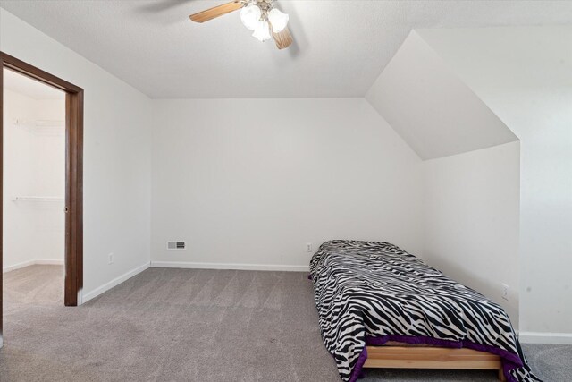 16248 Wabash Rd, Waldron, MI 49288 - carpeted bedroom with a ceiling fan, baseboards, and vaulted ceiling
