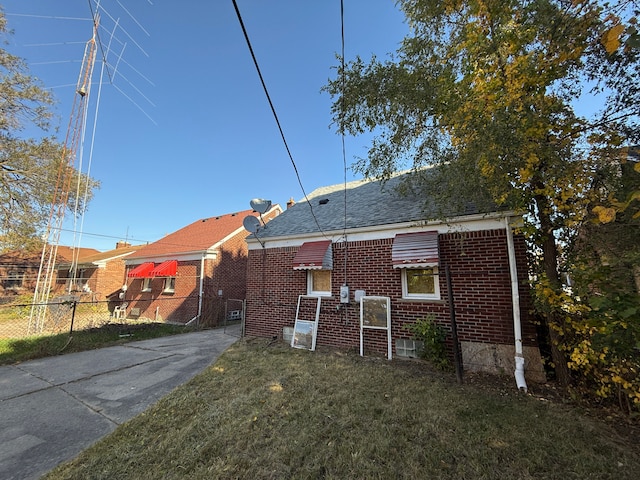 rear view of house featuring a yard