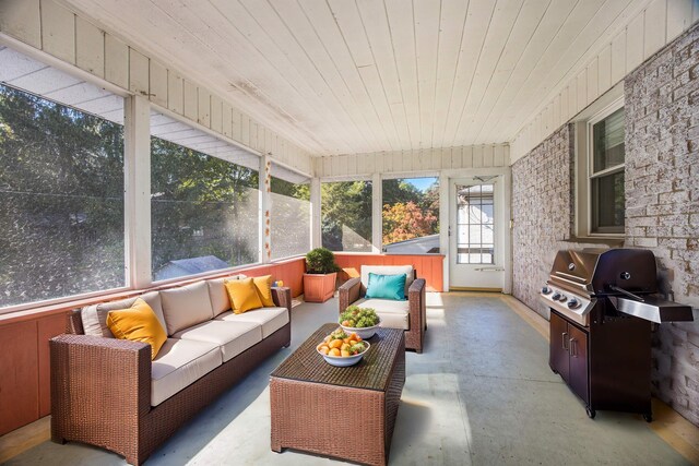 sunroom featuring wood ceiling