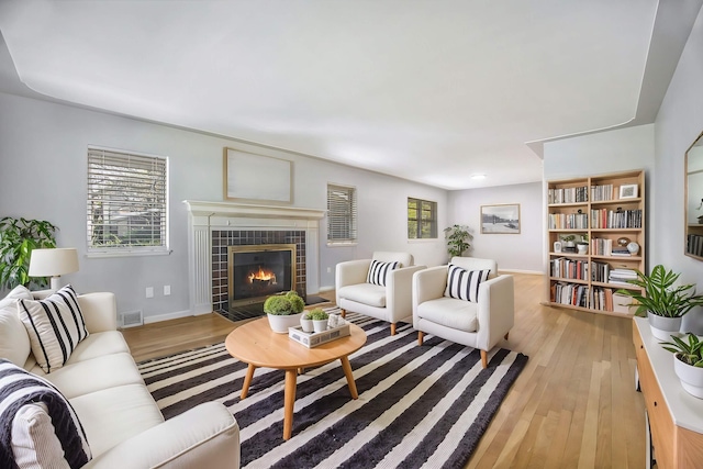 living room featuring a fireplace and light hardwood / wood-style flooring