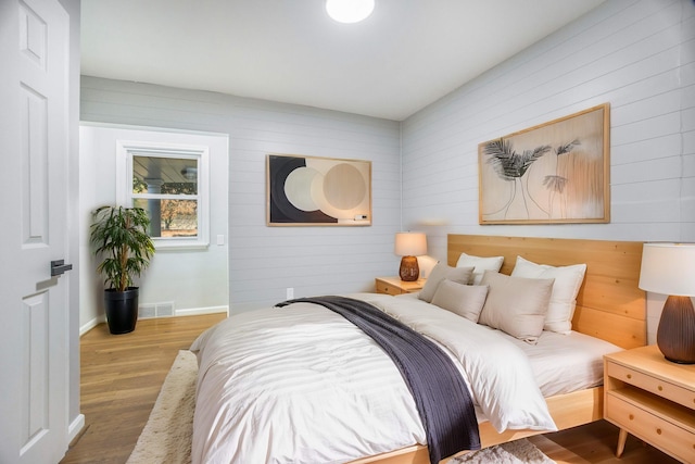 bedroom with hardwood / wood-style floors