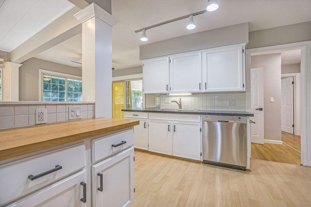 kitchen with backsplash, stainless steel dishwasher, sink, light hardwood / wood-style flooring, and white cabinets