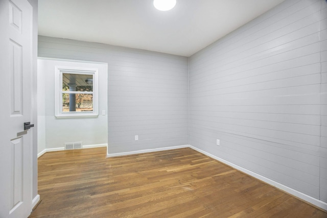 spare room with hardwood / wood-style flooring