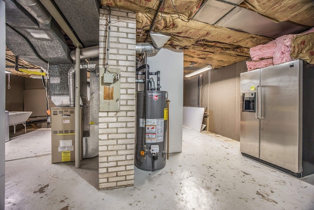 basement with water heater and stainless steel refrigerator with ice dispenser