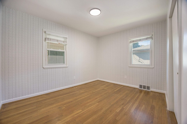 empty room with hardwood / wood-style flooring