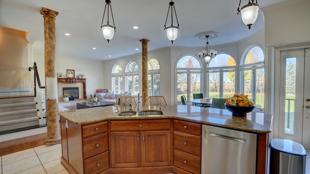 kitchen with sink, stainless steel dishwasher, ornamental molding, decorative light fixtures, and decorative columns