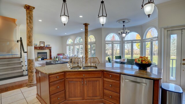5280 O Connor Pass, Swartz Creek, MI 48473 - kitchen with a sink, stainless steel dishwasher, ornamental molding, healthy amount of natural light, and a glass covered fireplace