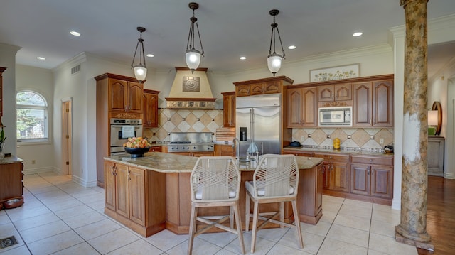 kitchen featuring decorative columns, built in appliances, decorative backsplash, and an island with sink