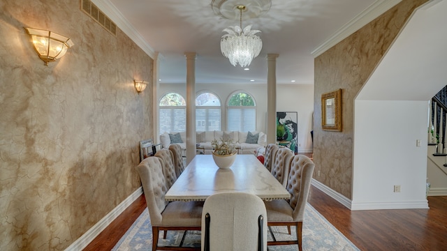 dining space with ornate columns, dark hardwood / wood-style flooring, a chandelier, and ornamental molding