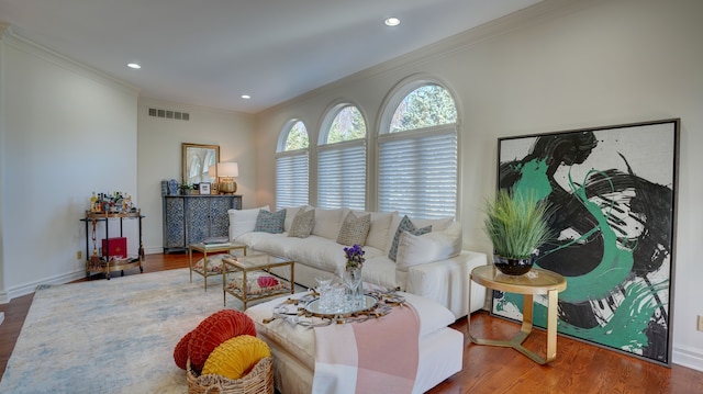 living room featuring hardwood / wood-style flooring and crown molding