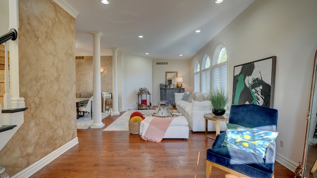 living room with dark hardwood / wood-style flooring, ornamental molding, and decorative columns