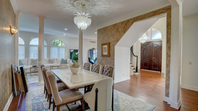 5280 O Connor Pass, Swartz Creek, MI 48473 - dining space featuring stairs, wood finished floors, ornate columns, baseboards, and crown molding