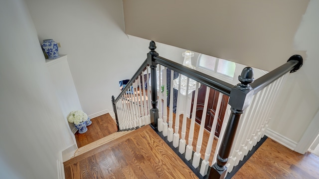 stairway featuring wood-type flooring