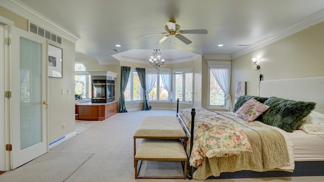 carpeted bedroom with a multi sided fireplace, ceiling fan with notable chandelier, and ornamental molding