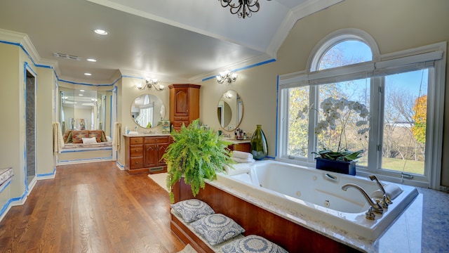 bathroom with hardwood / wood-style flooring, vanity, crown molding, and vaulted ceiling