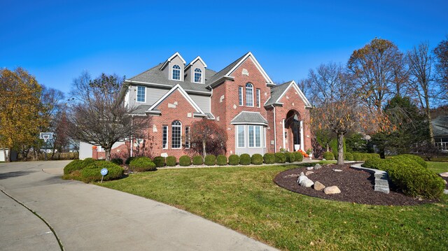 5280 O Connor Pass, Swartz Creek, MI 48473 - view of front of property with brick siding, a front lawn, and driveway