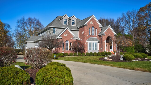 5280 O Connor Pass, Swartz Creek, MI 48473 - colonial home with brick siding, driveway, and a front lawn