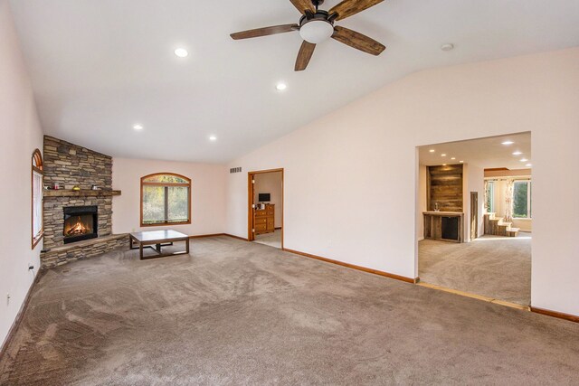 6700 Bethuy Rd, Ira, MI 48023 - unfurnished living room with carpet floors, vaulted ceiling, plenty of natural light, a stone fireplace, and baseboards