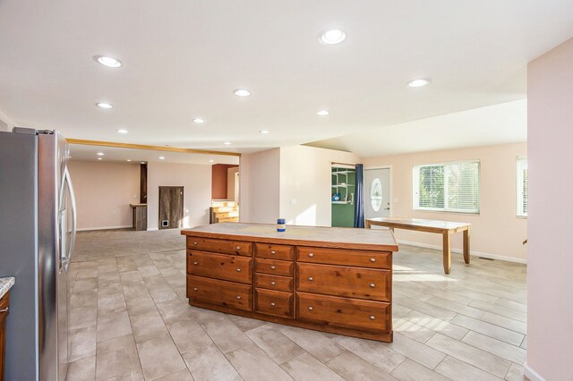 6700 Bethuy Rd, Ira, MI 48023 - kitchen featuring freestanding refrigerator, recessed lighting, brown cabinets, baseboards, and light countertops