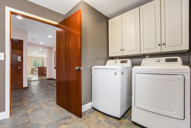 washroom featuring cabinets and independent washer and dryer