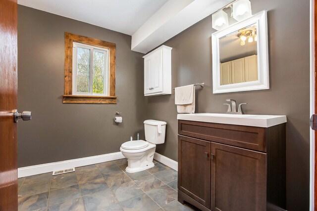 6700 Bethuy Rd, Ira, MI 48023 - half bath with baseboards, toilet, vanity, and stone finish flooring