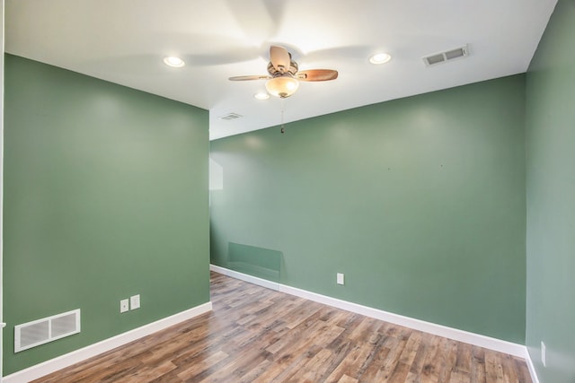 spare room with hardwood / wood-style floors and ceiling fan