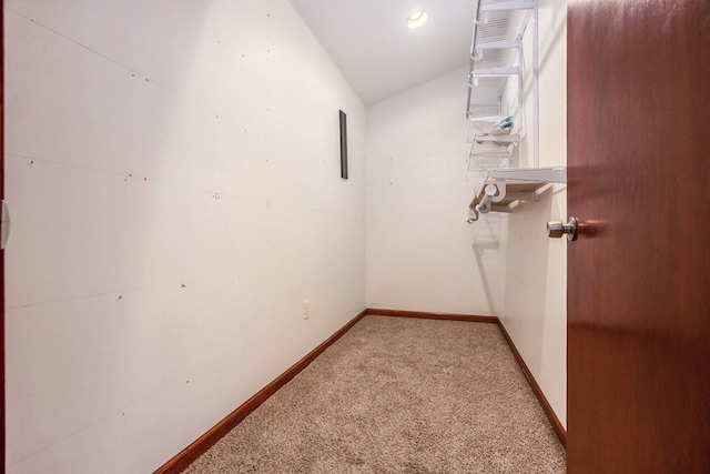 spacious closet with light carpet and lofted ceiling