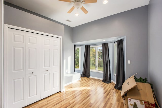 bedroom featuring ceiling fan, a closet, and light hardwood / wood-style floors