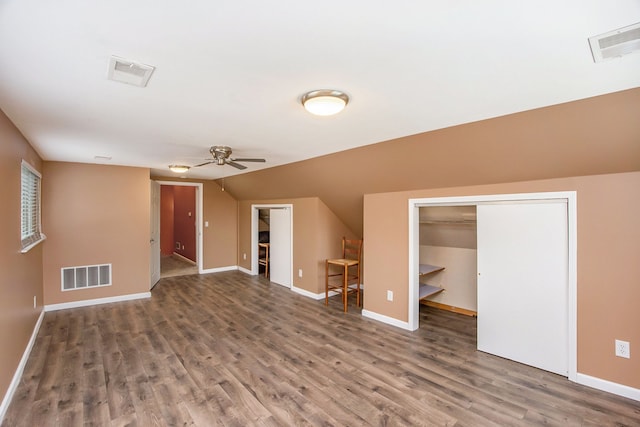 bonus room with ceiling fan and hardwood / wood-style flooring