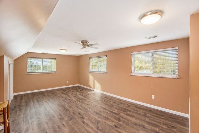 unfurnished room featuring dark hardwood / wood-style floors, ceiling fan, and lofted ceiling