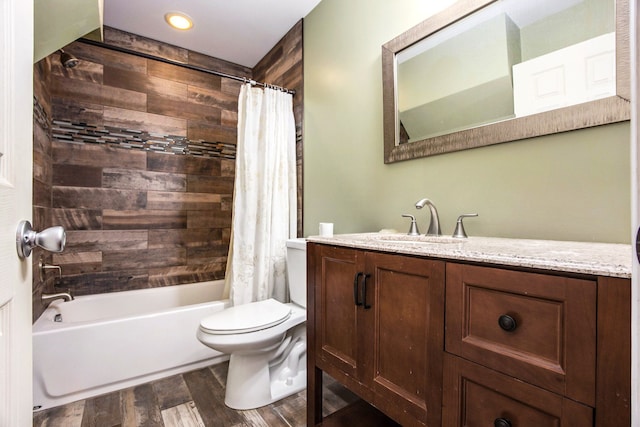 full bathroom featuring vanity, toilet, wood-type flooring, and shower / tub combo