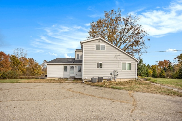 back of property featuring central AC